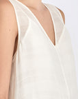 Close-up on the woven texture and godet panel seam of the Off White Lenox Dress.