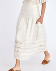 Model wearing the Luanda High-Waist Skirt in Off White.