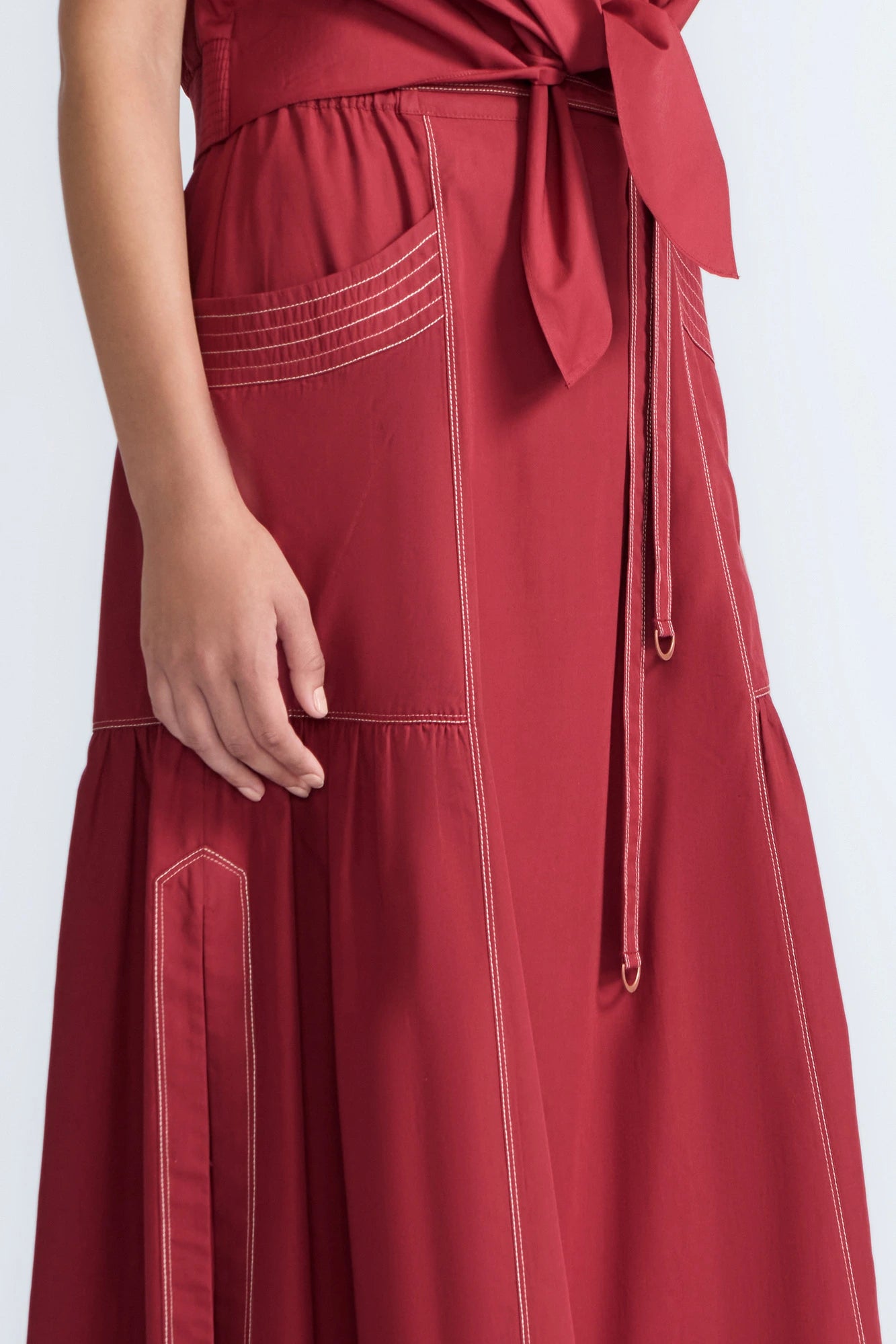 Detail of the adjustable waistband with metal toppers on the Milena Skirt.