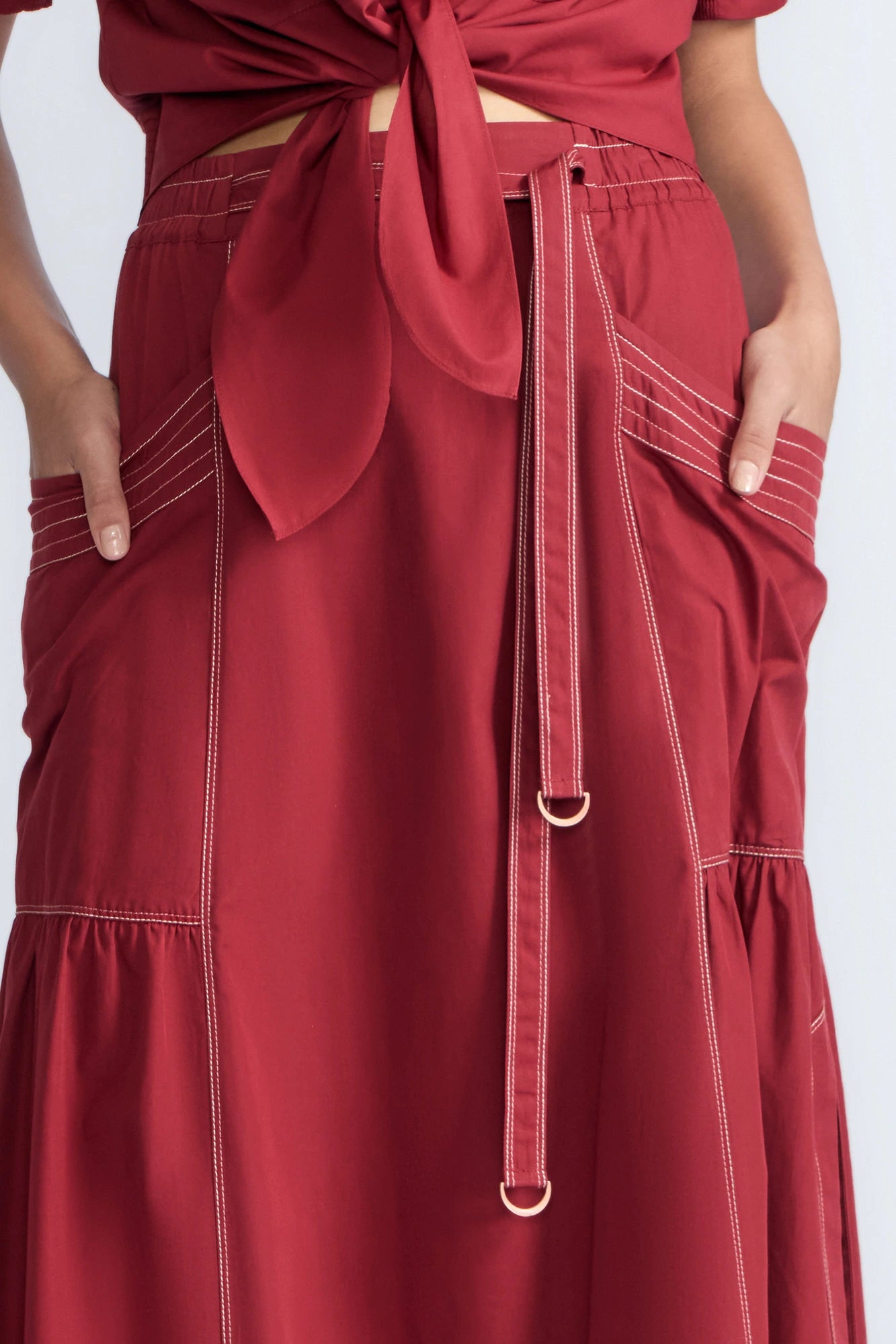 Detail of the adjustable waistband with metal toppers on the Milena Skirt.