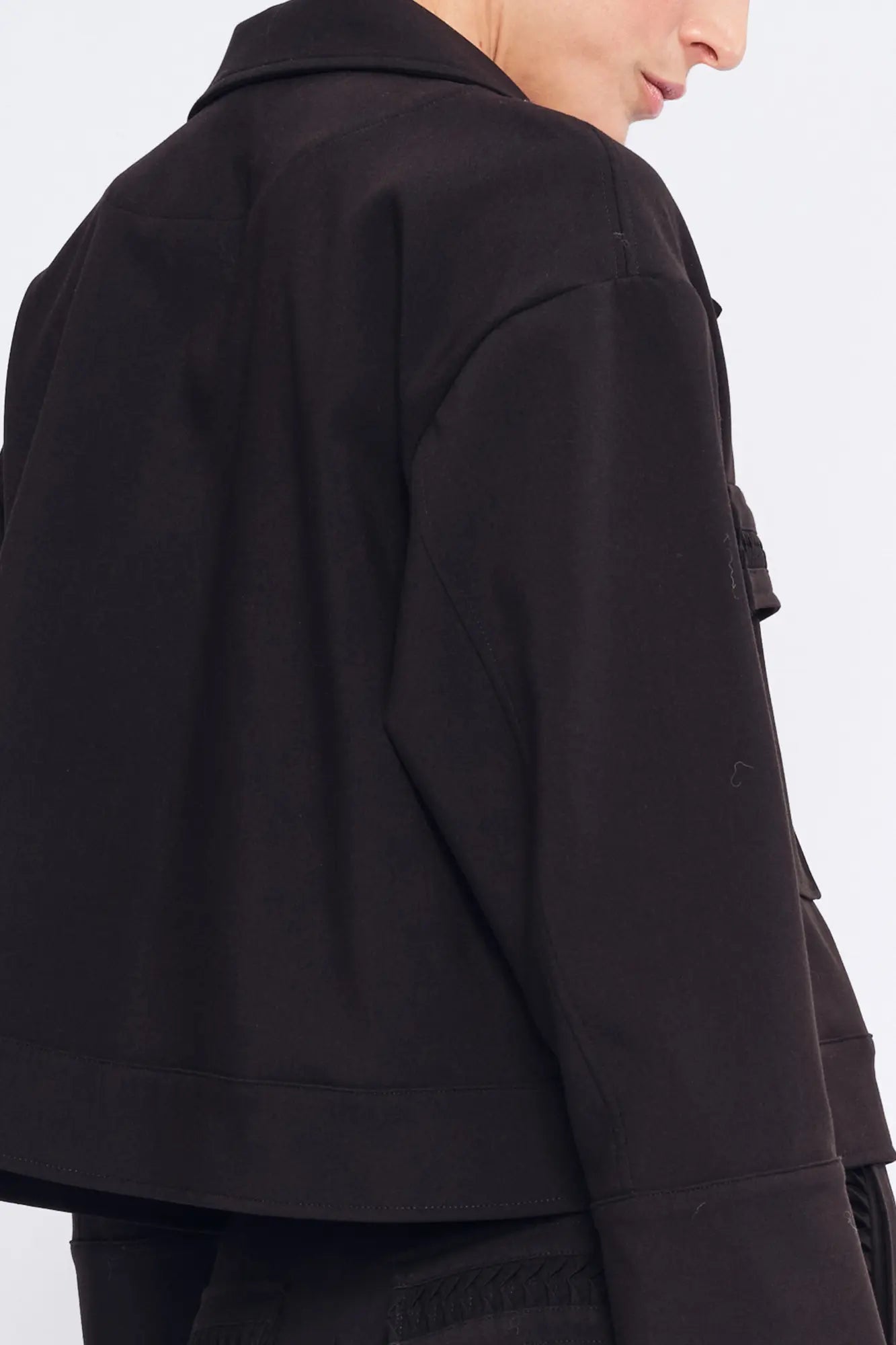 Elegant back view of the black Parker Jacket, highlighting its clean, tailored lines.