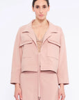 Front view of the Parker Jacket in Rose, showcasing its versatile tie-front design and tailored collar.