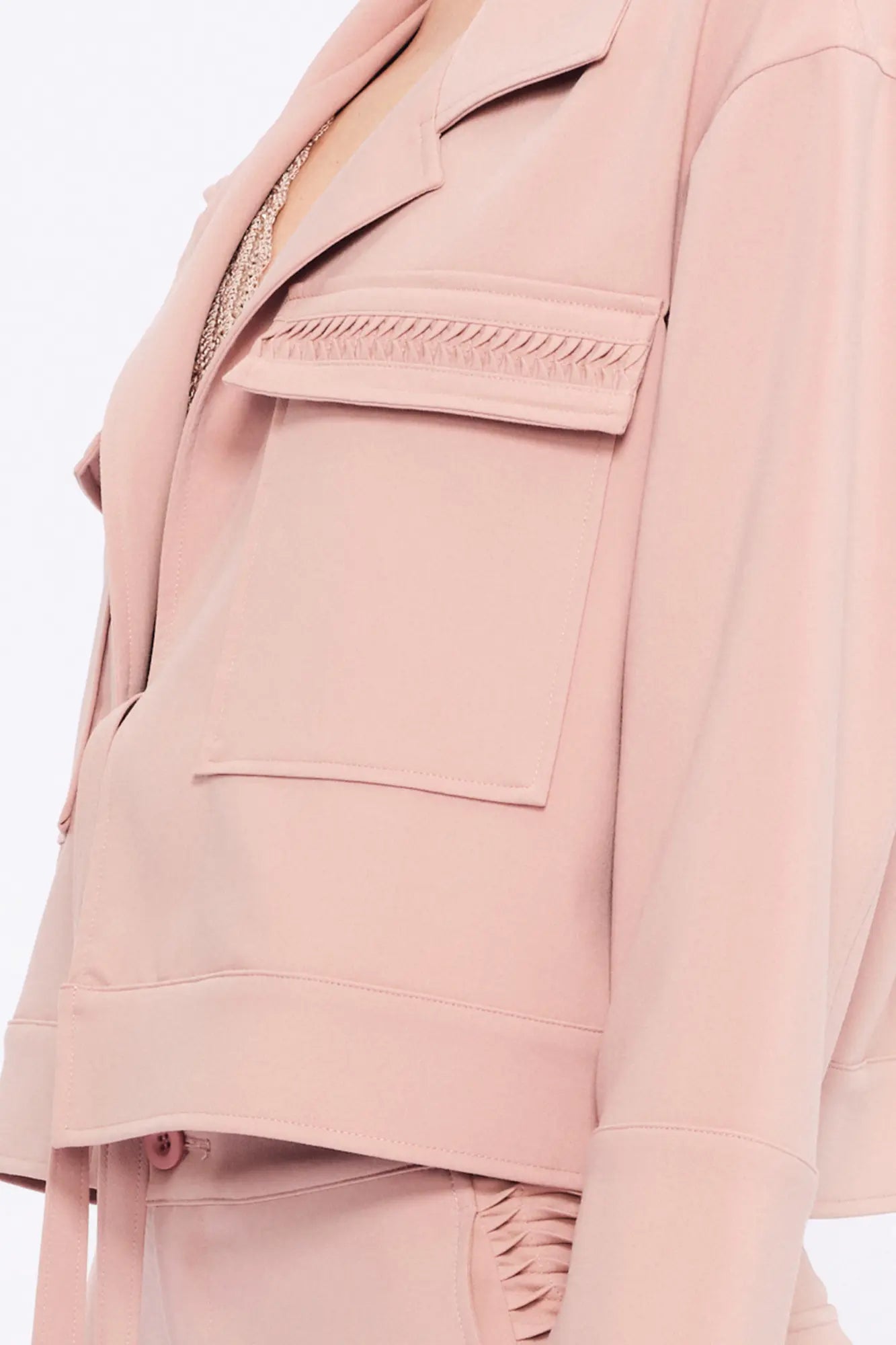  Close-up of the soft, raised gathered detail on the flap pocket of the Rose Parker Jacket.