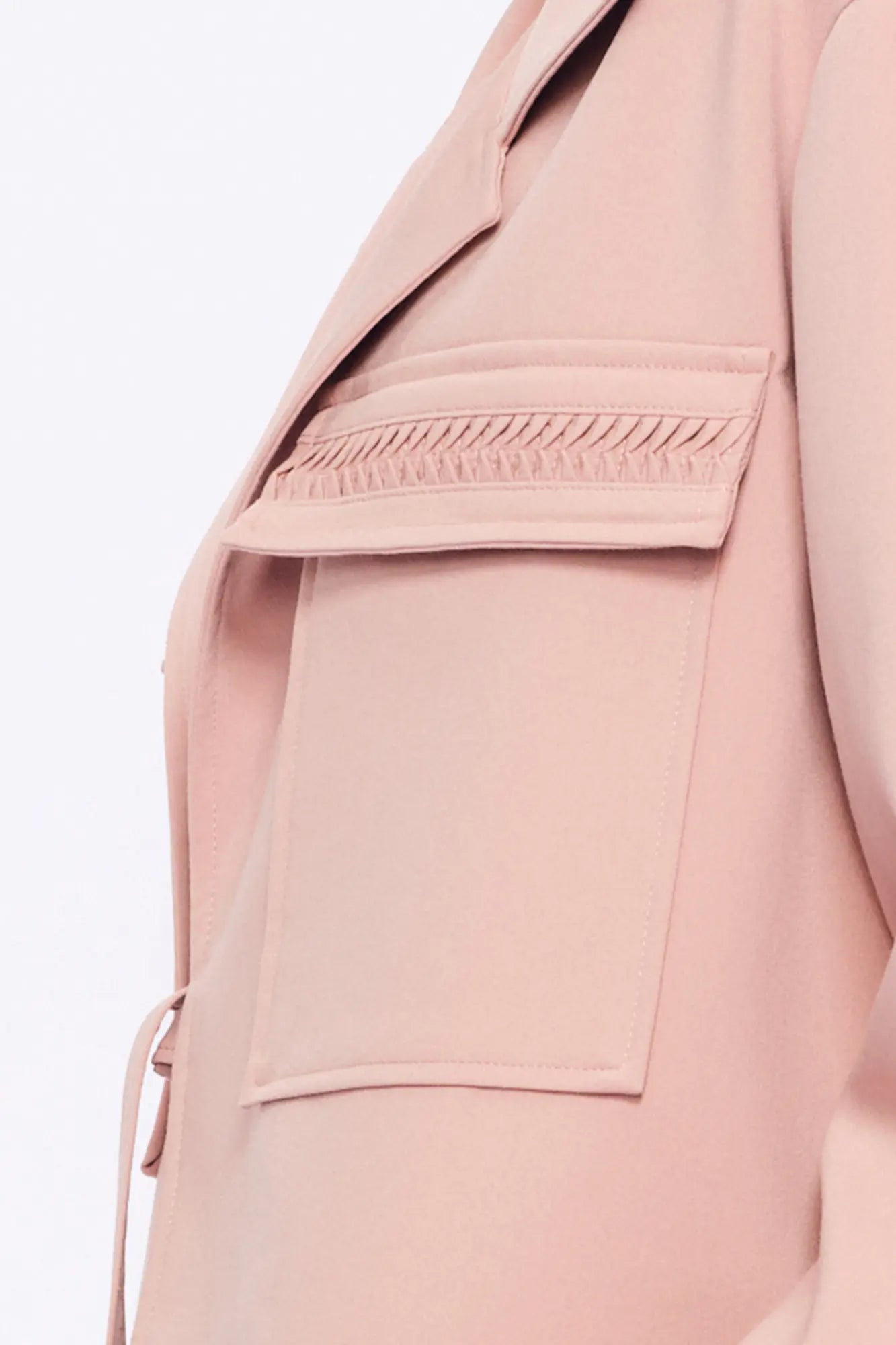 Close-up of the soft, raised gathered detail on the flap pocket of the Rose Parker Jacket.
