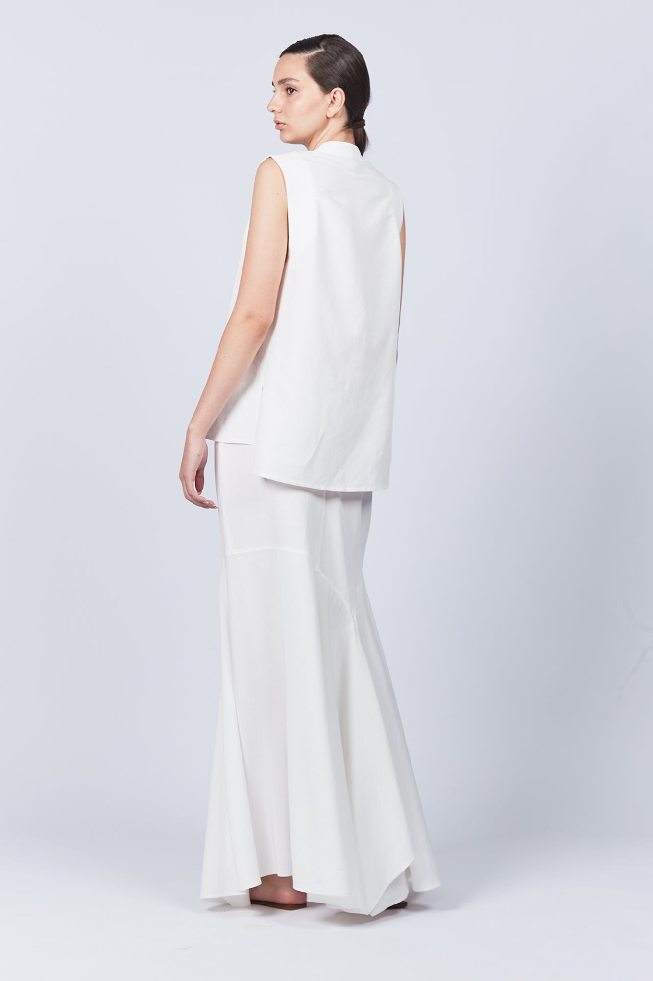 Penny Skirt in Off White with a high-waisted flowing silhouette, offering timeless elegance for any wardrobe.