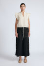 Pria Blouse in Prestine – Elegant sleeveless blouse in pima cotton with tonal V-neck, Greca trim, ruffle detail, and hem with pullers.