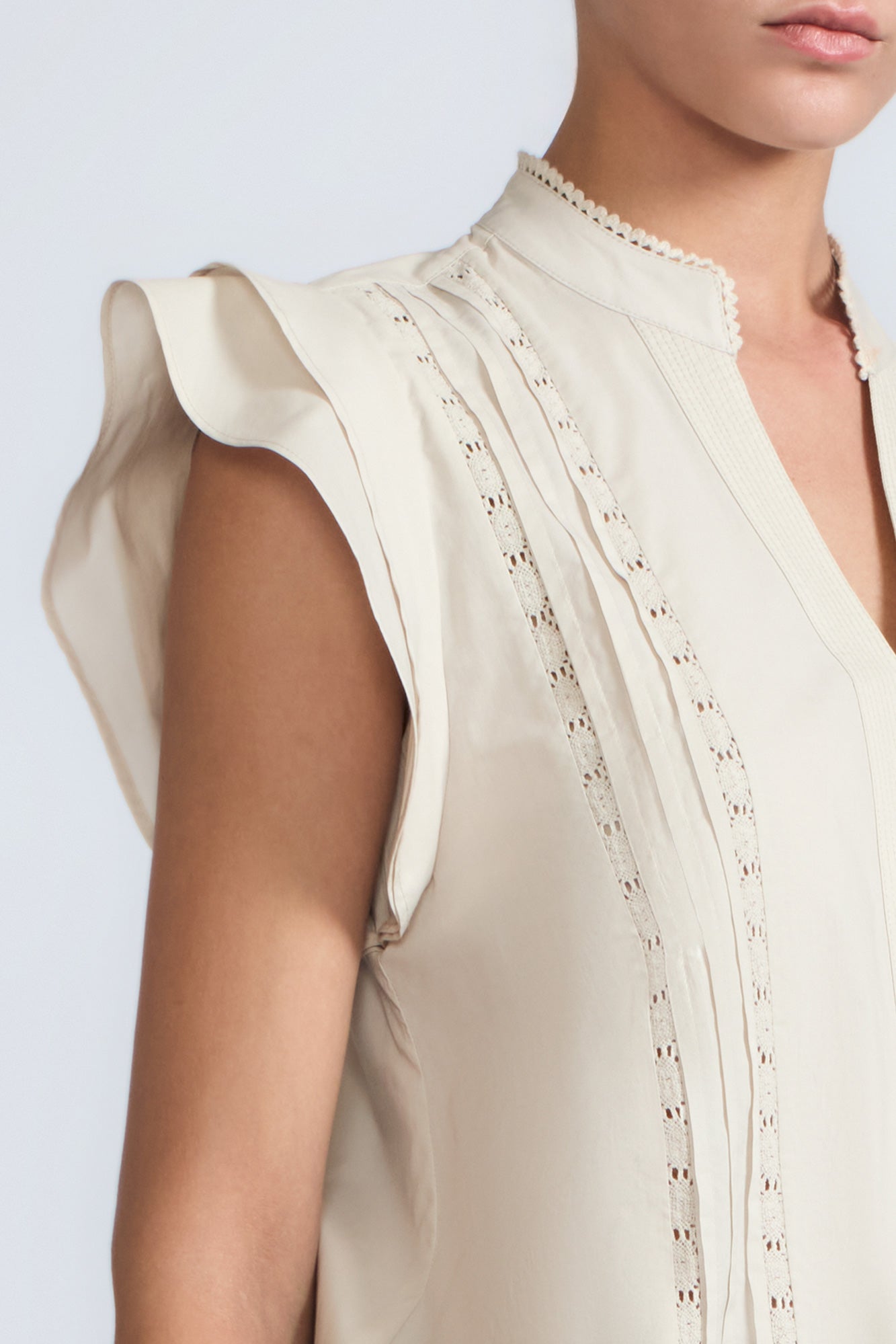 Pria Blouse in Prestine – Elegant sleeveless blouse in pima cotton with tonal V-neck, Greca trim, ruffle detail, and hem with pullers.