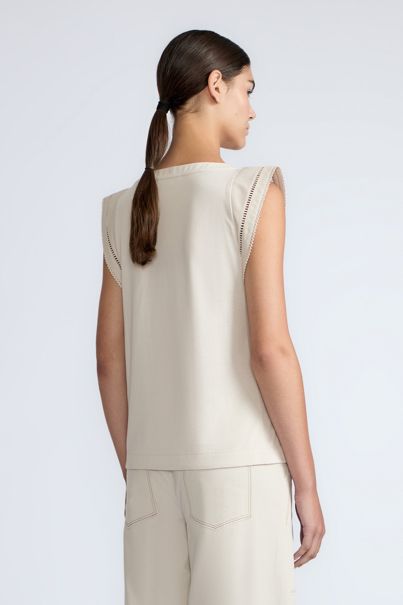 Regina Top in Prestine – Pima cotton knit top with round neckline, Greca lace detailing, side slits, and relaxed dropped sleeves.