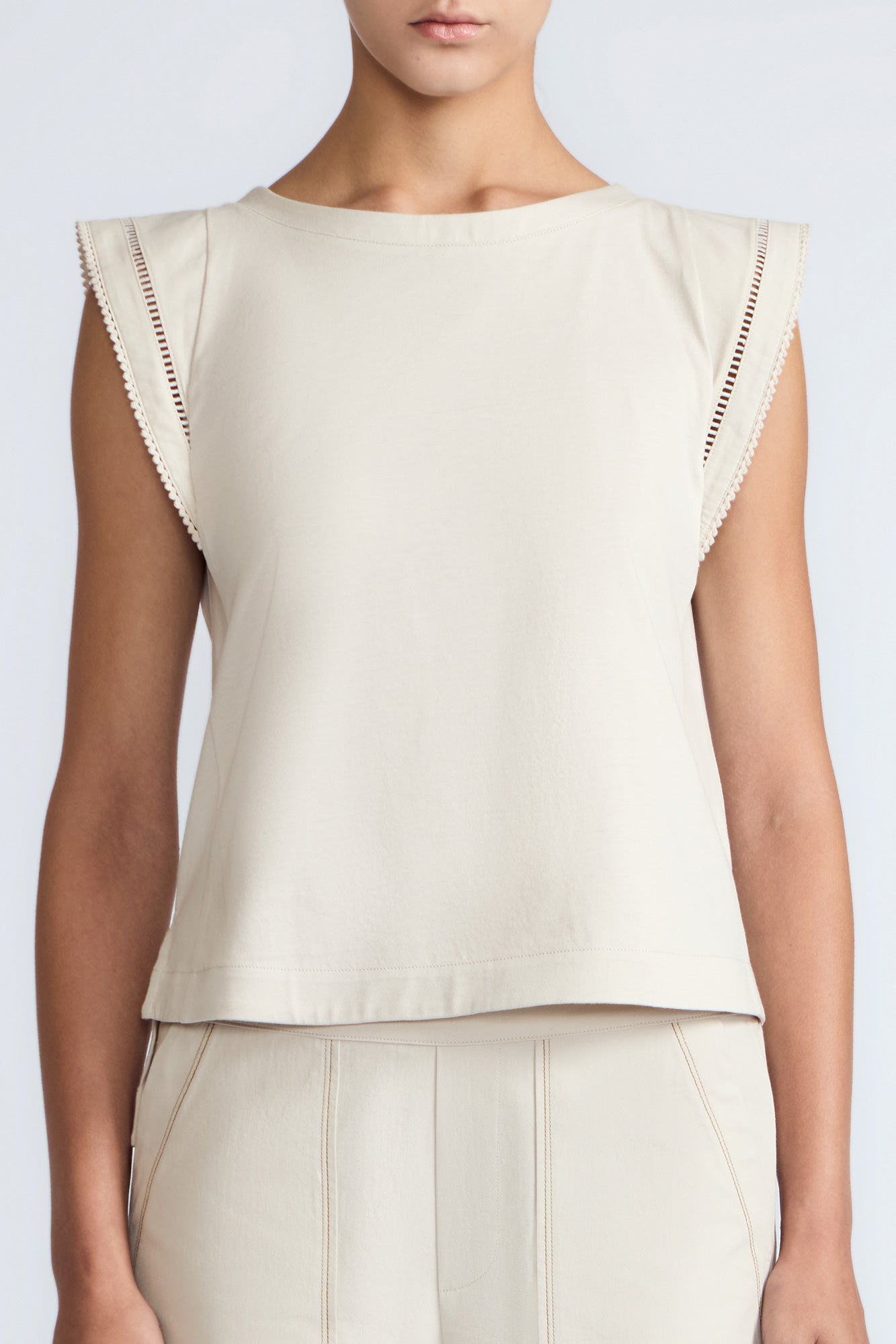 Regina Top in Prestine – Pima cotton knit top with round neckline, Greca lace detailing, side slits, and relaxed dropped sleeves.