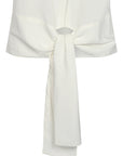 Shelby Blouse in Off White with a round neck, button-back detail, elasticated short sleeves, and flattering tie hem.