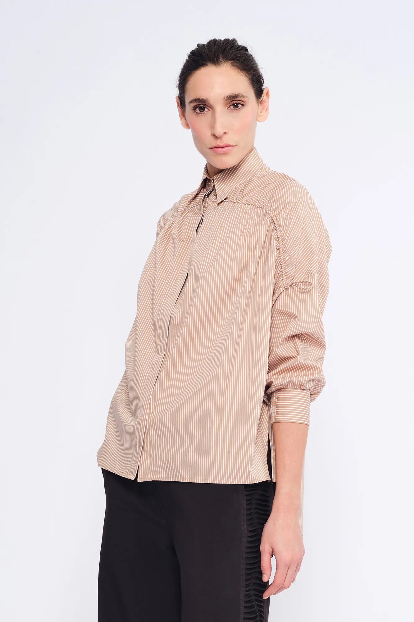 The Star Blouse in a timeless Camel, featuring its crisp shirt collar and the rich tone of its Peruvian cotton.