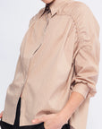Detail shot of the adjustable drawstring on the shoulder, a signature of the Camel Star Blouse's transformative design.