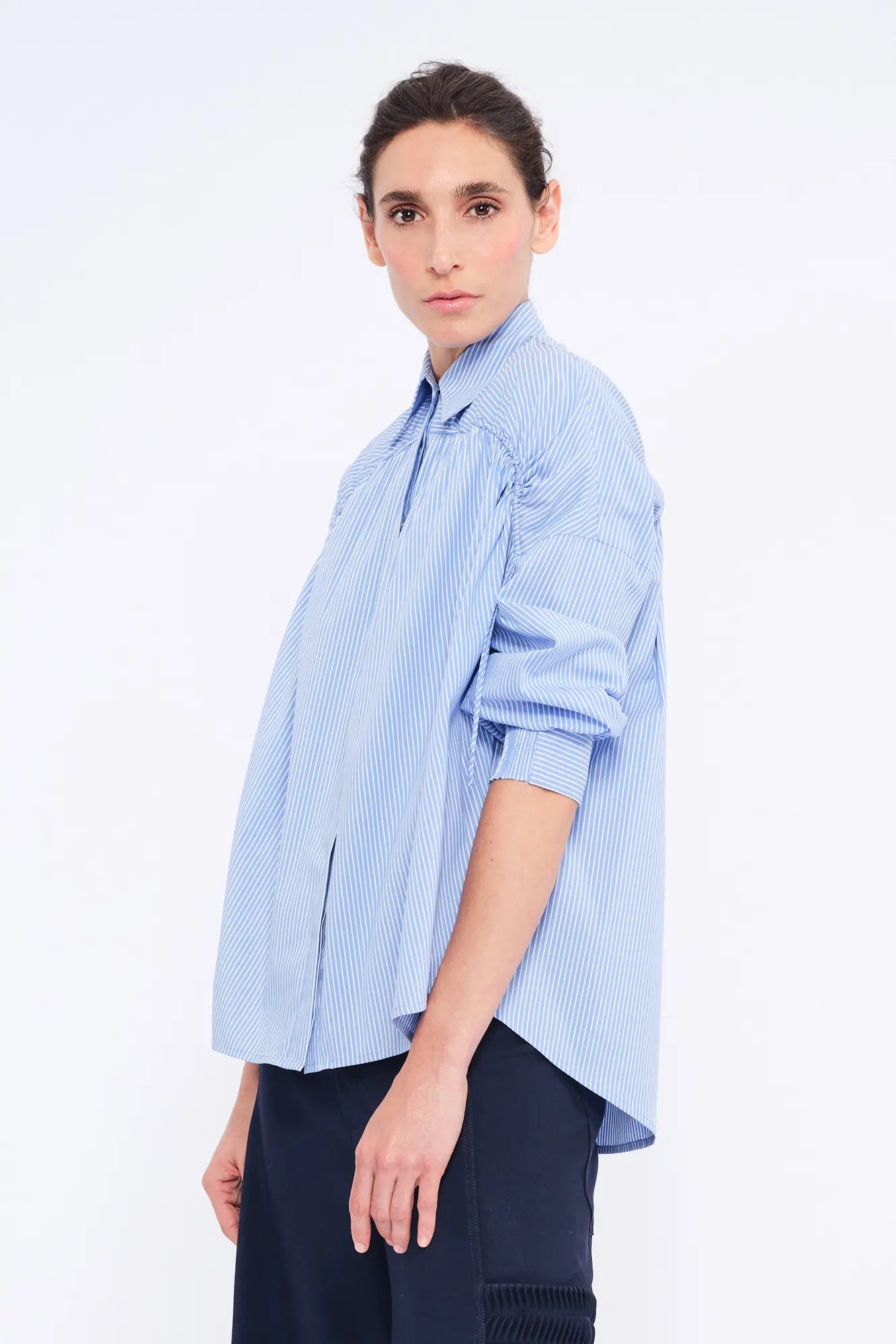 Side profile of the Light Blue Star Blouse, highlighting the soft volume of the adjustable gathered shoulder.