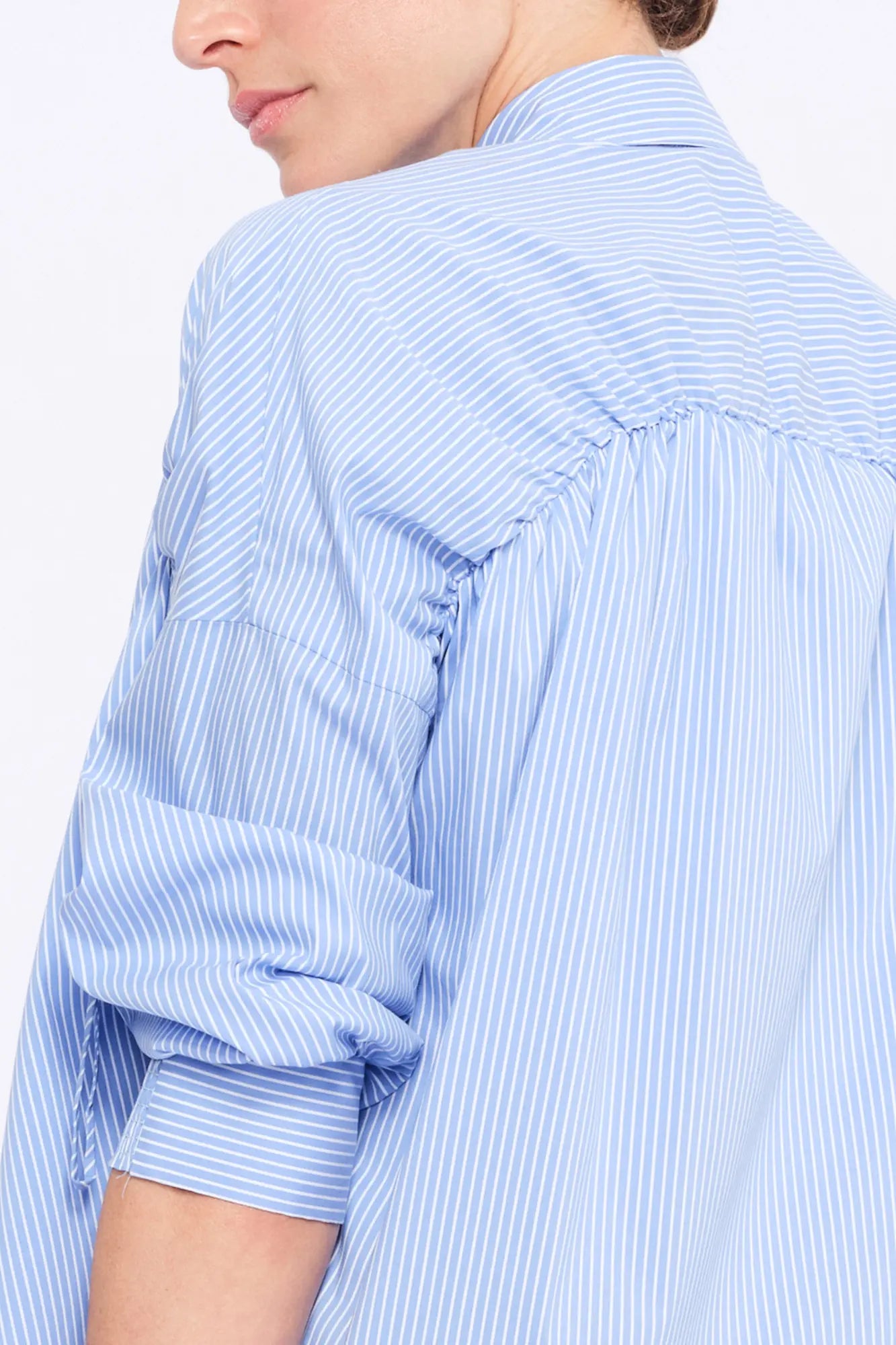 Close-up of the innovative drawstring that defines the shoulder of the Light Blue Star Blouse.