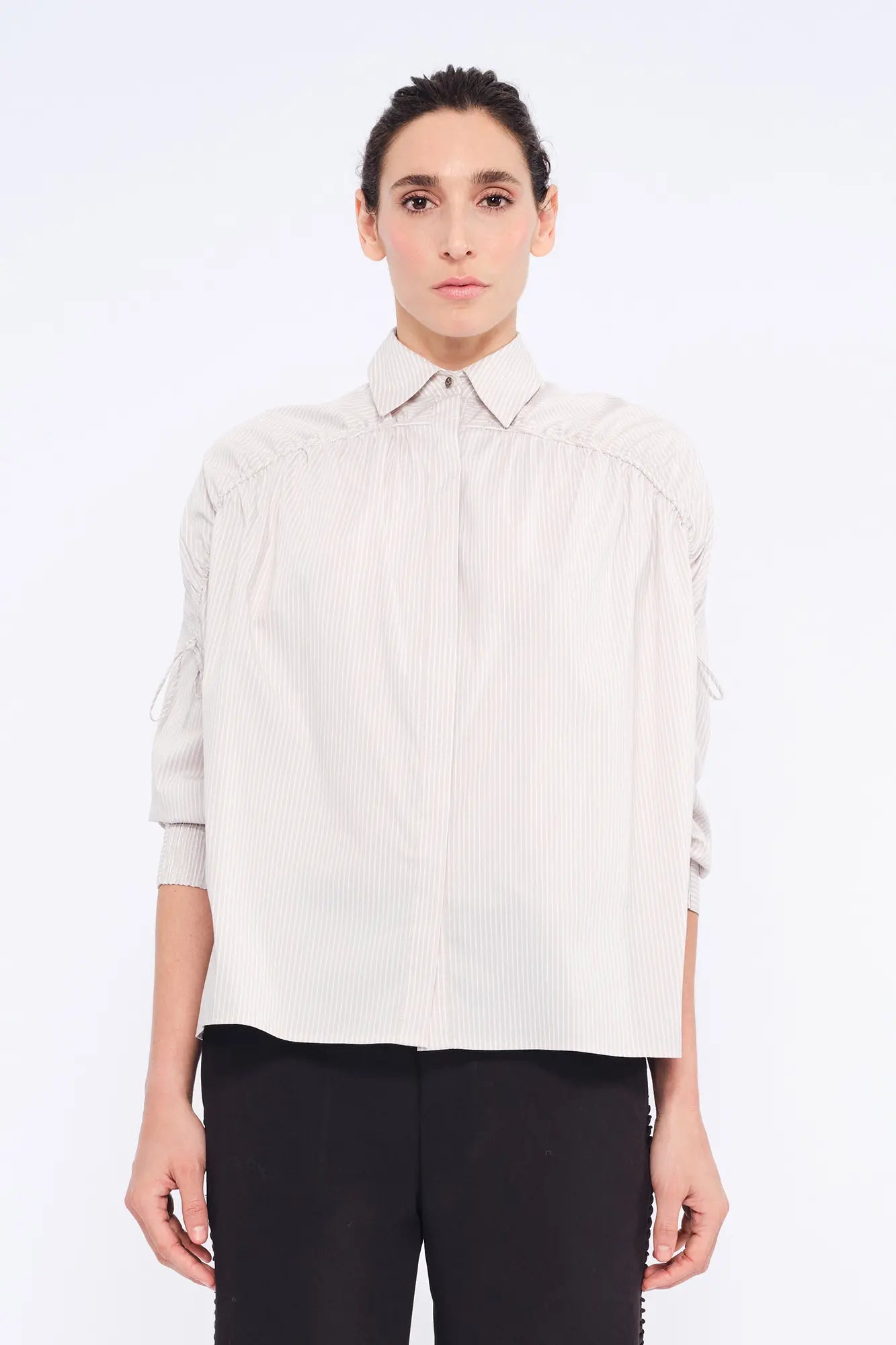 Front view of the Star Blouse in Sand, showcasing its classic collar and the elegant drape of its Peruvian cotton fabric.