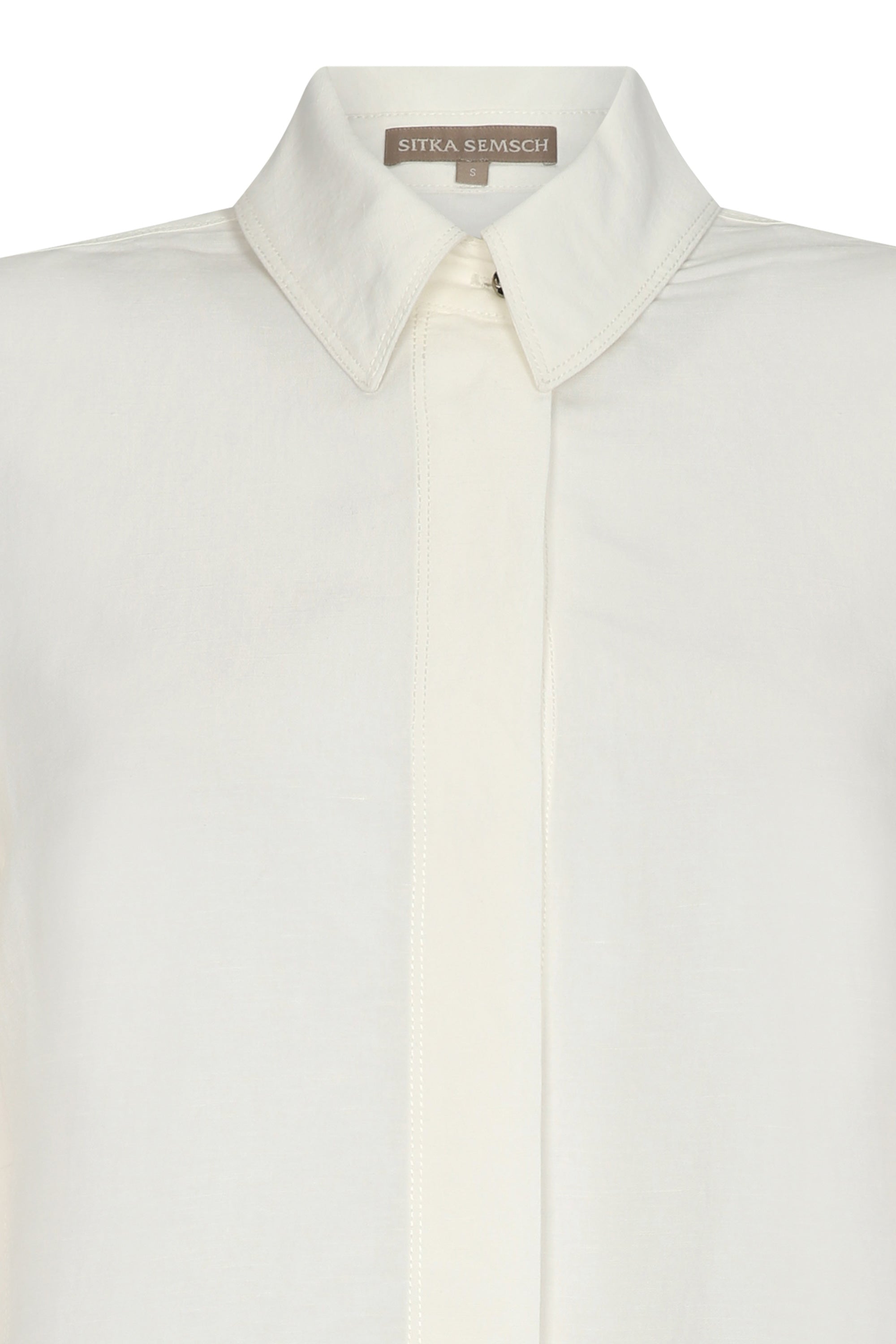 Tatiana Blouse in Off White with a modern shirt collar, hidden button placket, and airy 3/4 puff sleeves.