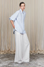 Tatiana Blouse in Sky showcasing a sophisticated shirt collar, concealed button placket, and romantic puff sleeves.