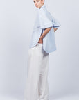 Tatiana Blouse in Sky showcasing a sophisticated shirt collar, concealed button placket, and romantic puff sleeves.