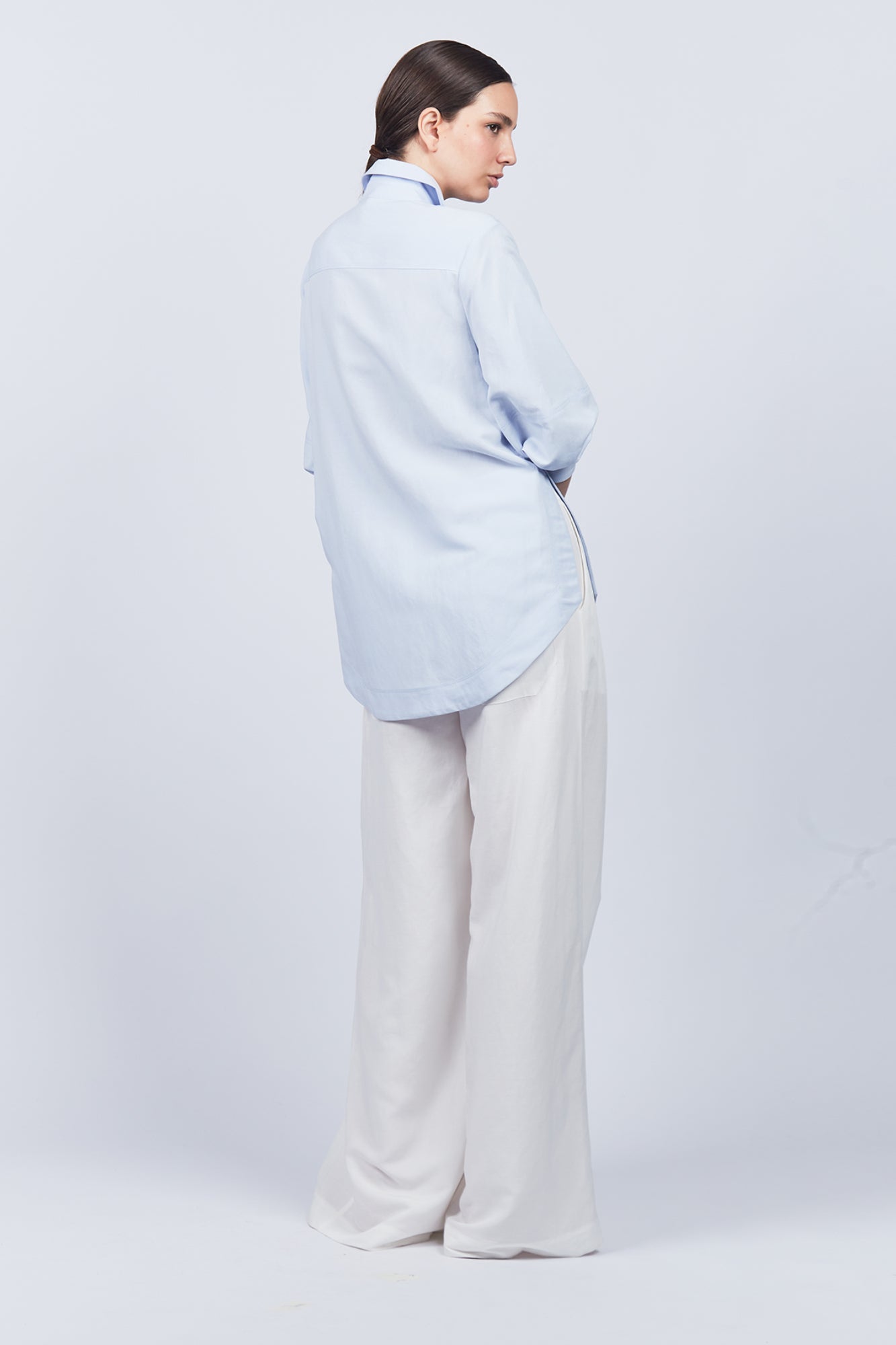 Tatiana Blouse in Sky showcasing a sophisticated shirt collar, concealed button placket, and romantic puff sleeves.