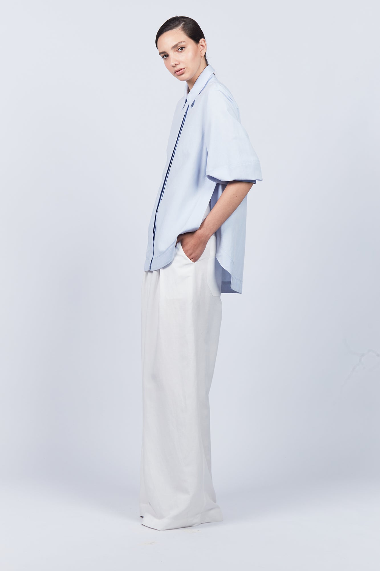 Tatiana Blouse in Sky showcasing a sophisticated shirt collar, concealed button placket, and romantic puff sleeves.