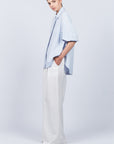 Tatiana Blouse in Sky showcasing a sophisticated shirt collar, concealed button placket, and romantic puff sleeves.