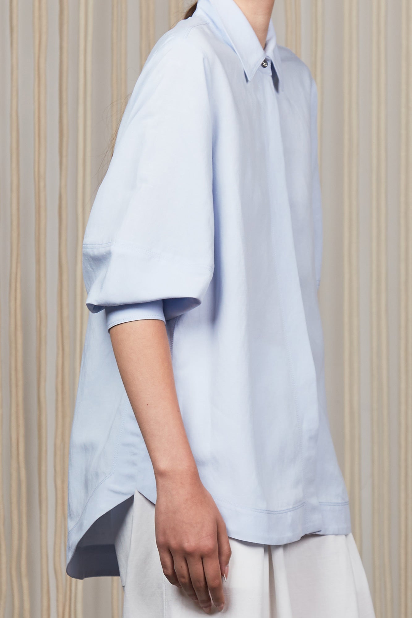 Tatiana Blouse in Sky showcasing a sophisticated shirt collar, concealed button placket, and romantic puff sleeves.