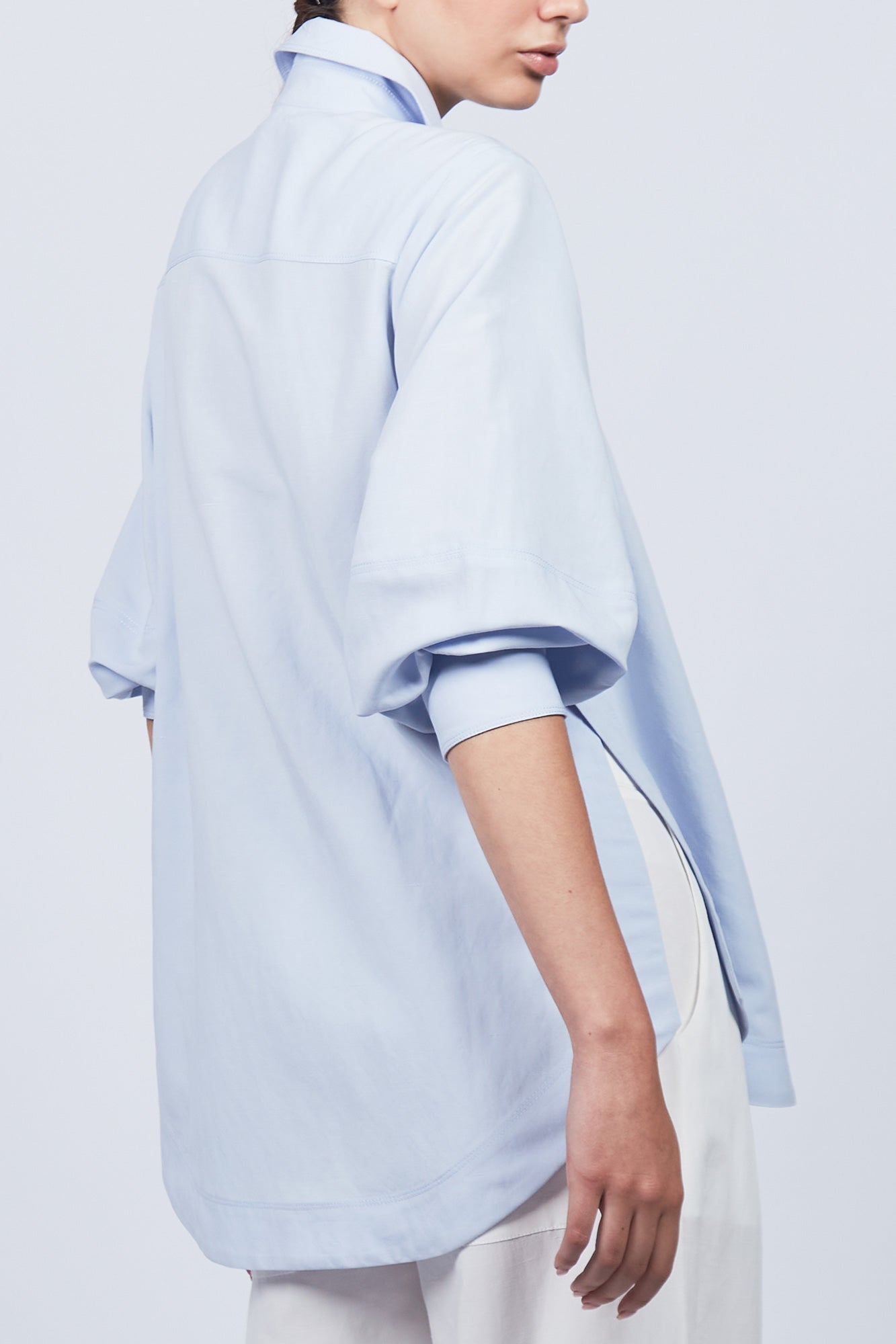 Tatiana Blouse in Sky showcasing a sophisticated shirt collar, concealed button placket, and romantic puff sleeves.