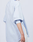 Tatiana Blouse in Sky showcasing a sophisticated shirt collar, concealed button placket, and romantic puff sleeves.