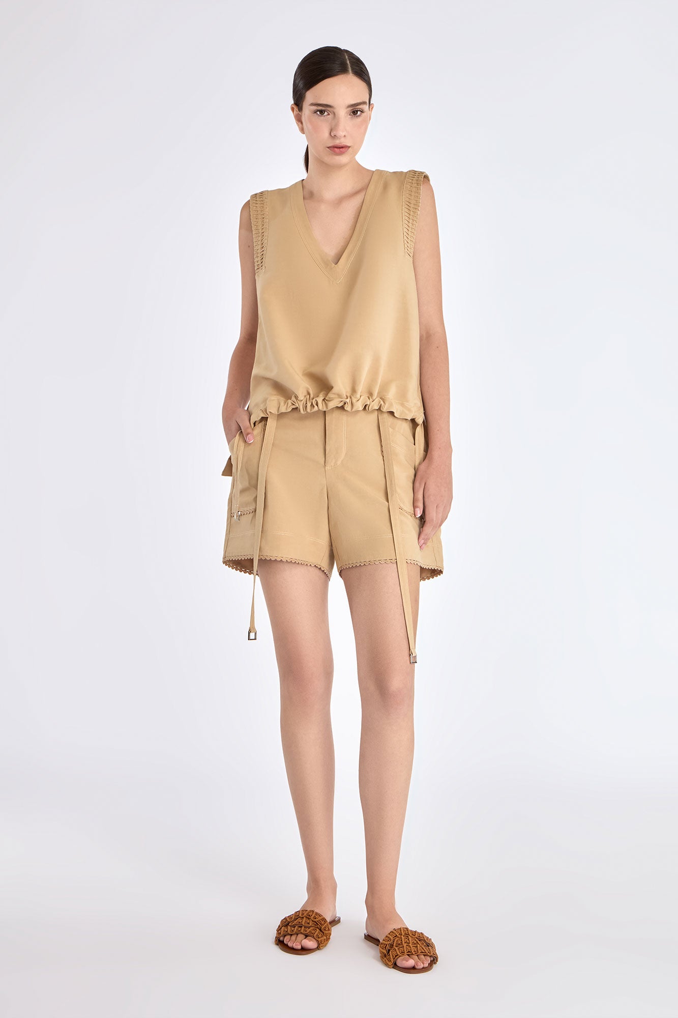 The Valencia Blouse in a rich Camel hue, showing its sleeveless design and premium linen blend.