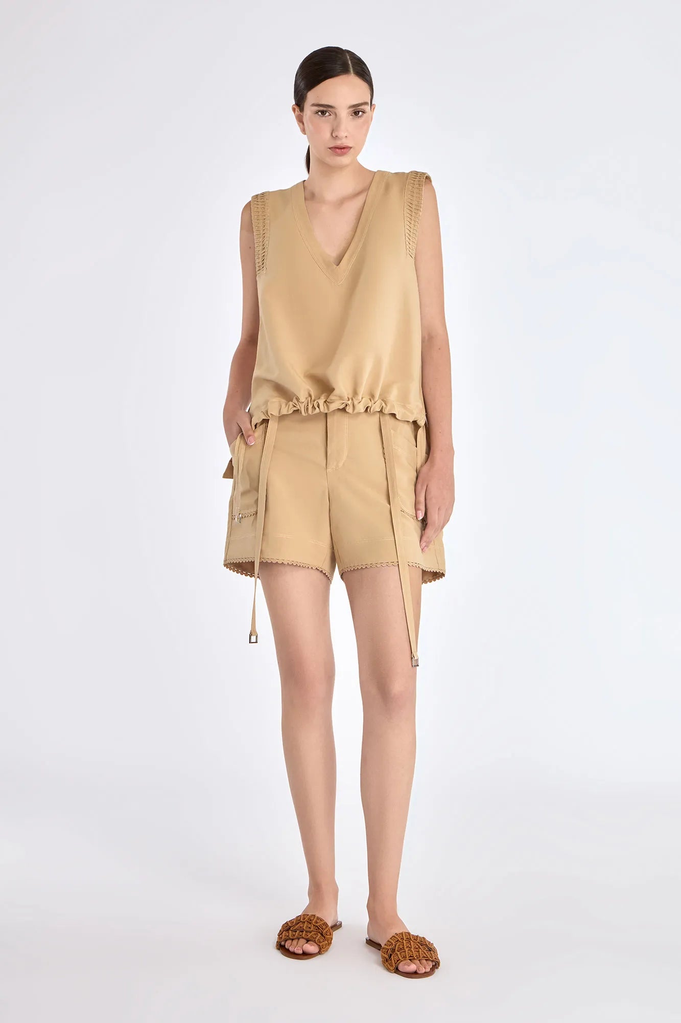 The Valencia Blouse in a rich Camel hue, showing its sleeveless design and premium linen blend.