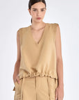 The Valencia Blouse in a rich Camel hue, showing its sleeveless design and premium linen blend.