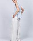 Veda Pant in Off White, wide-leg silhouette with functional back pockets for a tailored look.