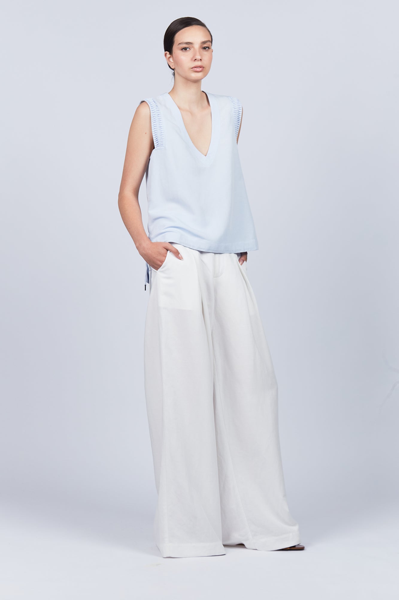 Veda Pant in Off White, wide-leg silhouette with functional back pockets for a tailored look.