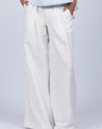 Veda Pant in Off White, wide-leg silhouette with functional back pockets for a tailored look.