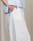 Veda Pant in Off White, wide-leg silhouette with functional back pockets for a tailored look.