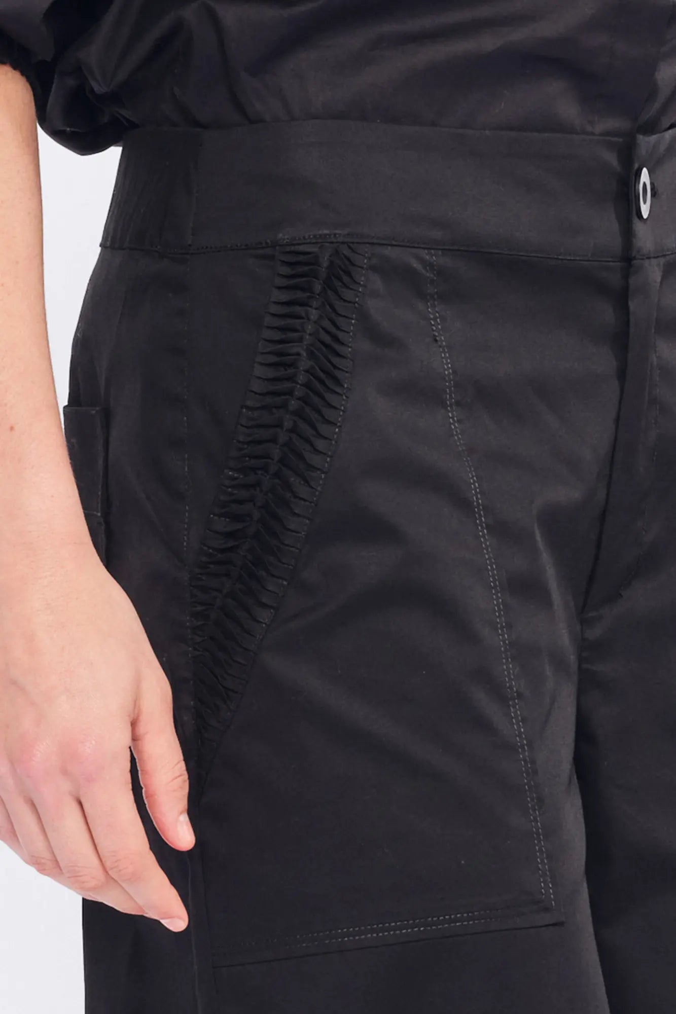 Detail shot of the tonal, sculptural embellishment on the hem of the black Viena Trouser.