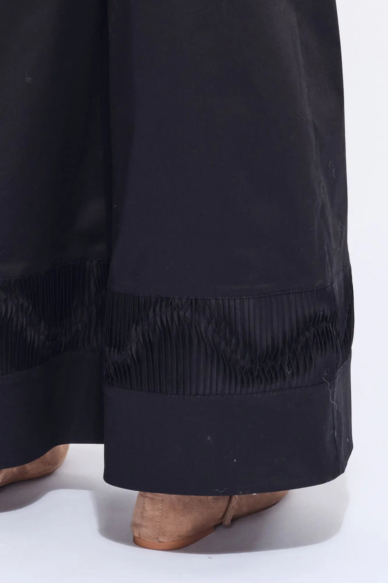 Detail shot of the tonal, sculptural embellishment on the hem of the black Viena Trouser.