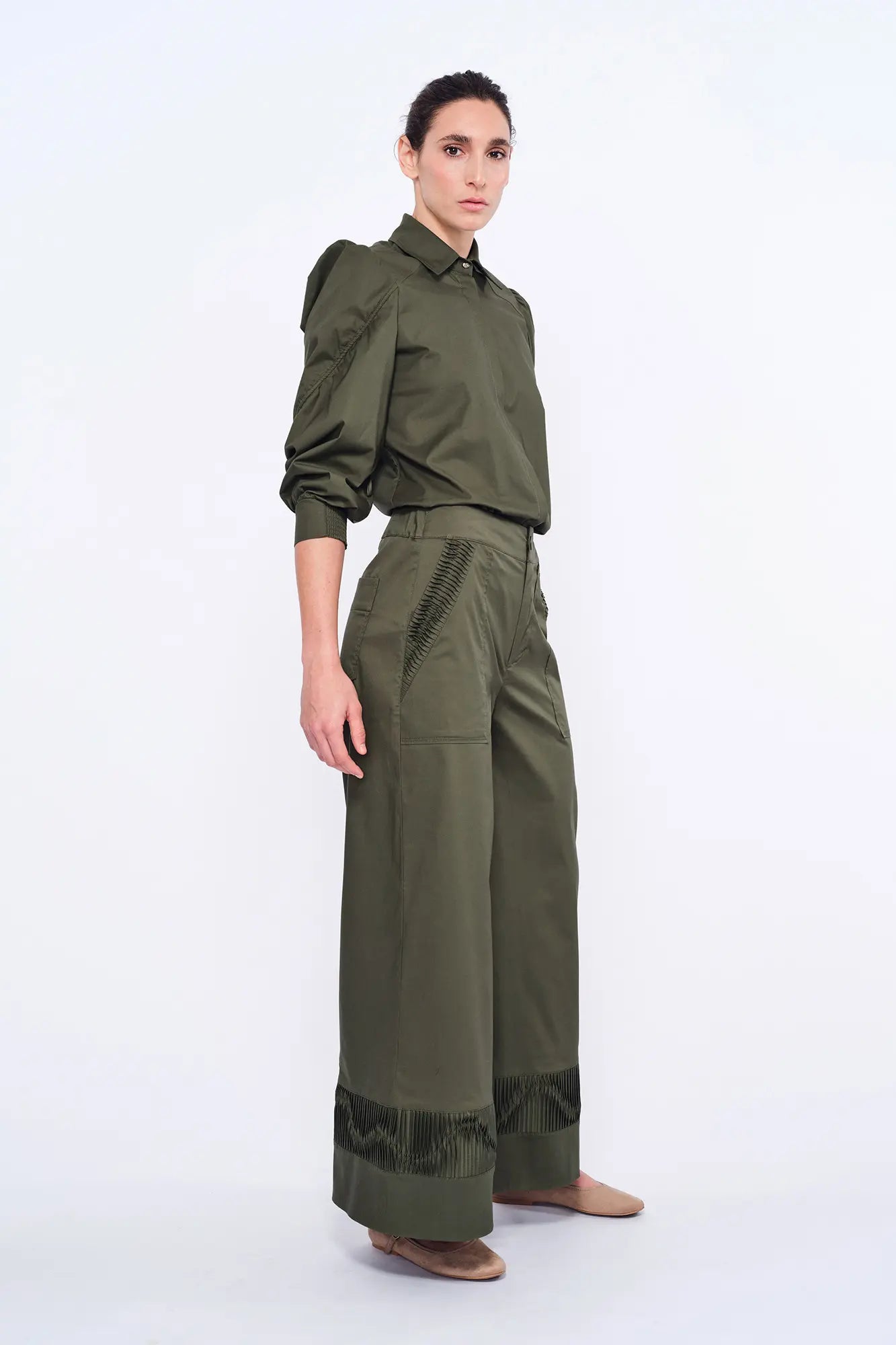 Side profile of the Olive Viena Trouser, highlighting the sculptural detail on the side pocket and hem.