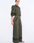 Side profile of the Olive Viena Trouser, highlighting the sculptural detail on the side pocket and hem.