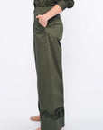 Side profile of the Olive Viena Trouser, highlighting the sculptural detail on the side pocket and hem.