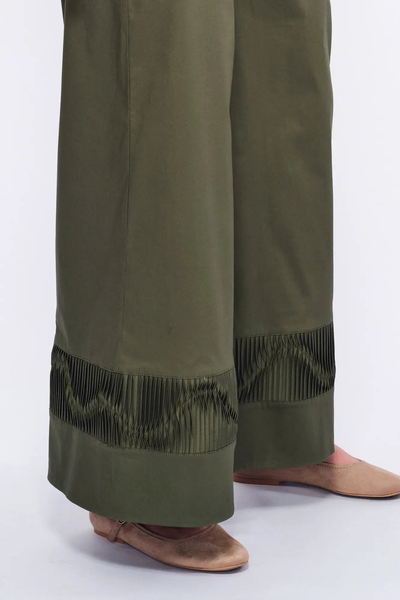 Close-up of the unique, raised sculptural embellishment on the hem of the Olive Viena Trouser.