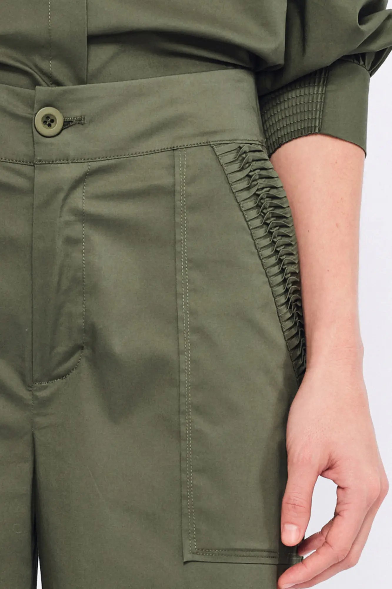 Close-up of the unique, raised sculptural embellishment on the hem of the Olive Viena Trouser.