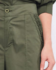 Close-up of the unique, raised sculptural embellishment on the hem of the Olive Viena Trouser.