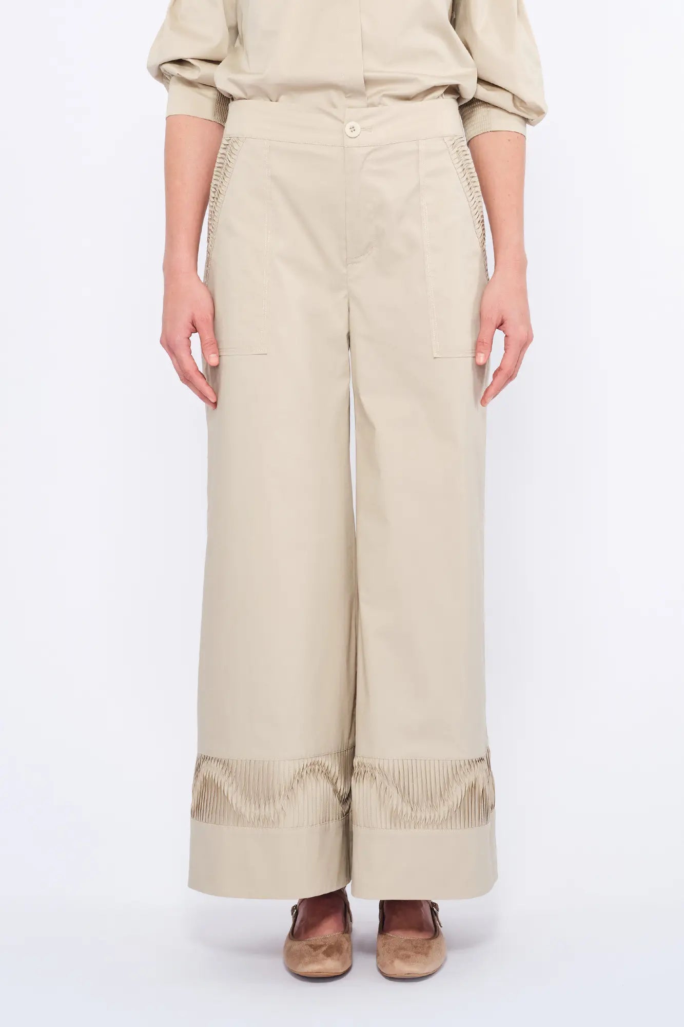 Front view of the Viena Trouser in pristine white, highlighting its sculptural design details.
