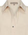 Zayla Blouse in Ecru, modern sleeveless blouse with a flattering V-neck and stylish hem.