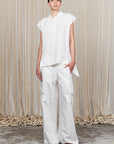 Zayla Blouse in Off White, elegant sleeveless blouse with an asymmetrical hem and shirt collar.