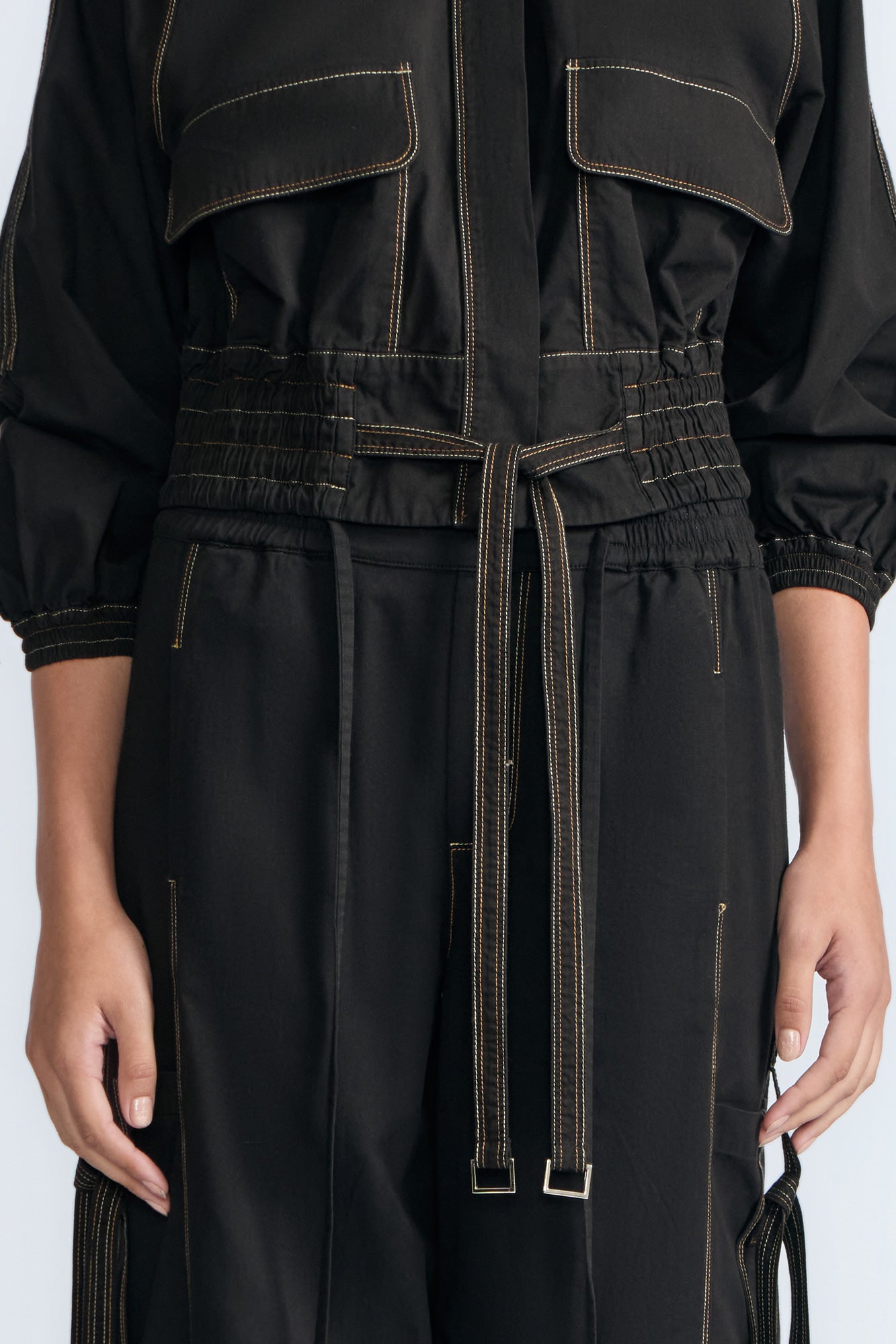 Zoe Jacket in Black – 100% cotton jacket with flap patch pockets, hidden buttons, long sleeves, and an adjustable drawstring hem.