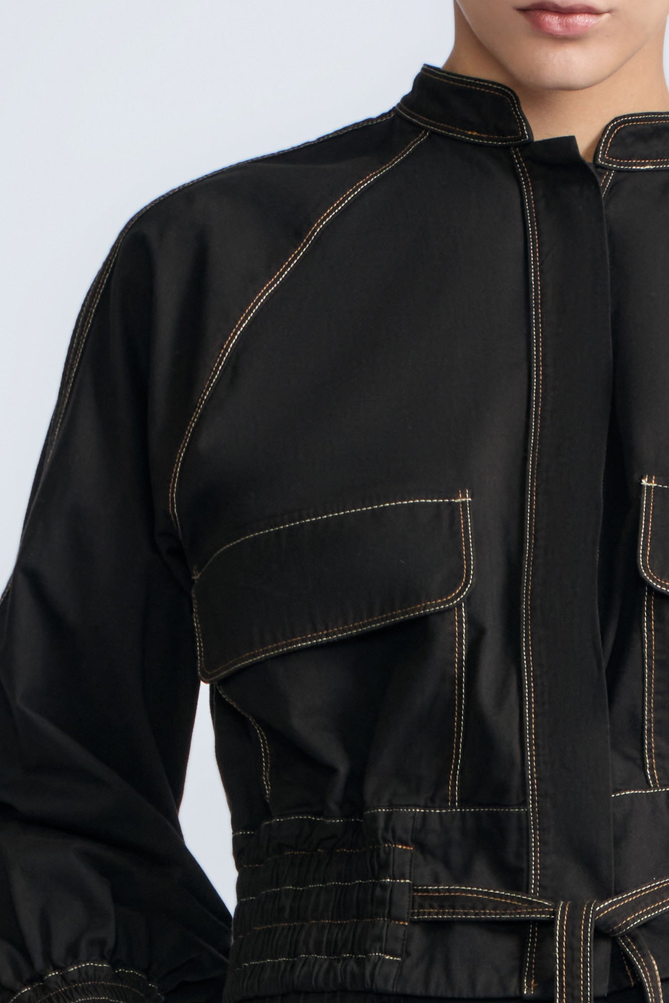 Zoe Jacket in Black – 100% cotton jacket with flap patch pockets, hidden buttons, long sleeves, and an adjustable drawstring hem.