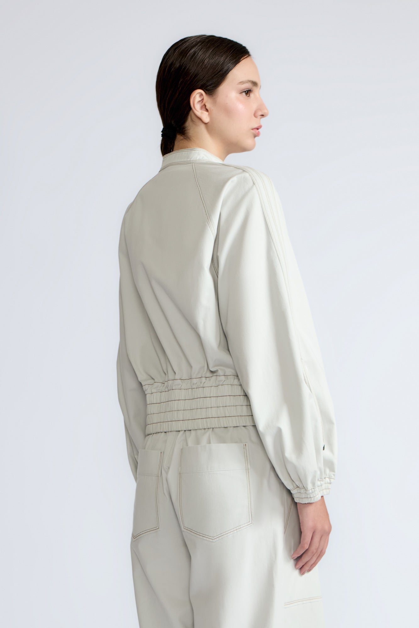 Zoe Jacket in Silver – 100% cotton jacket with flap patch pockets, hidden buttons, long sleeves, and an adjustable drawstring hem.
